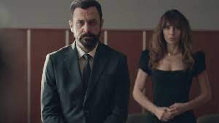 10 Days of a Good Man: A man and a woman look solemn