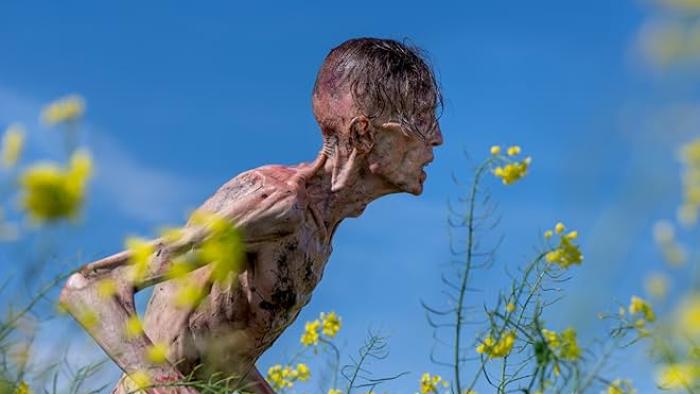 28 Years Later Movie: A rail-thin zombie with scraps of black hair on its head charges toward potential prey