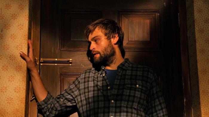 Unwelcome: A White man looking concerned blocks a locked door