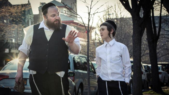 Menashe: An Orthodox Jewish man talking to his son