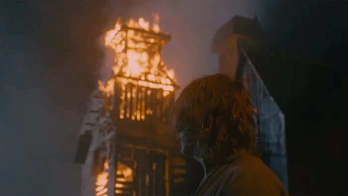 Harvest: A White man looks at a burning building