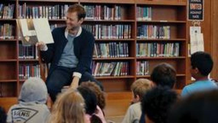 Story & Pictures By:  White man reads to kids