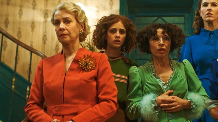 7 Women and a Murder movie: 4 white Italian women stand on a staircase looking down at something