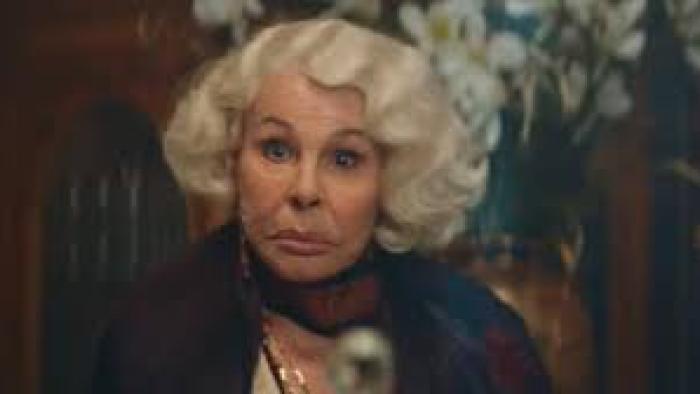 7 Women and a Murder movie: an older white Italian woman with white hair stares at the camera