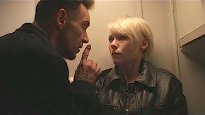 97 Minutes Movie: Alex (Jonathan Rhys Meyers) speaks intensely to Kim (MyAnna Buring), a finger up to his lips