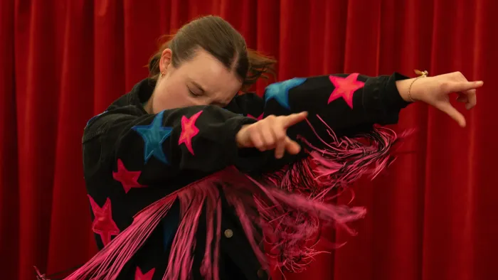 Sunny Dancer: Teen girl in a black jacket with pink stars and fringe, posing dynamically