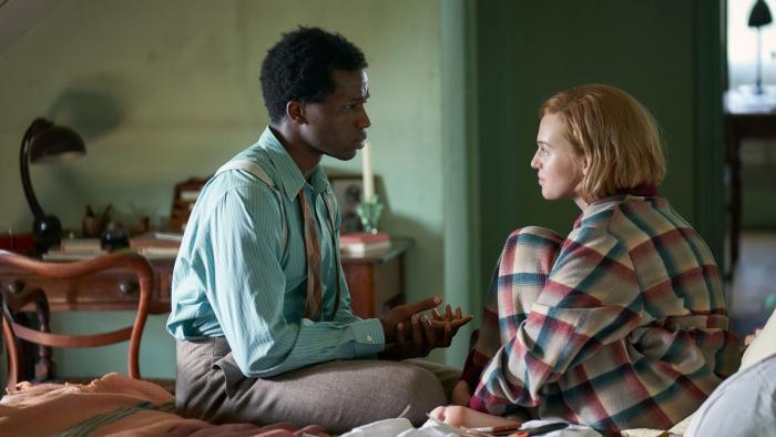 Mothering Sunday: Odessa Young and Sope Dirisu sitting on a bed