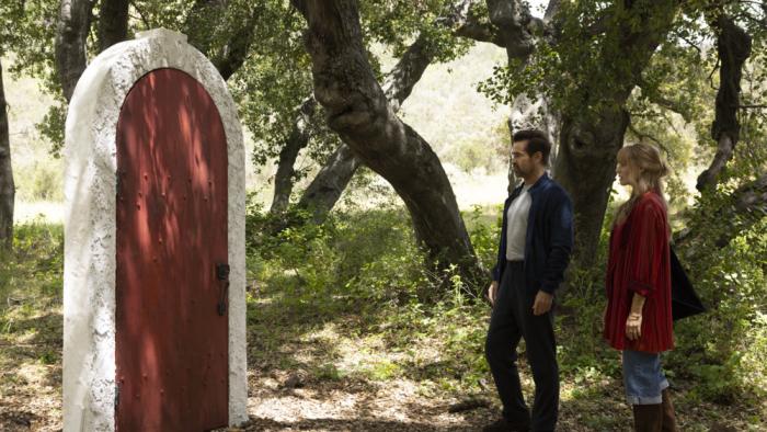 A Big Bold Beautiful Journey movie: Colin Farrell and Margot Robbie approach a freestanding red door in the middle of a forest