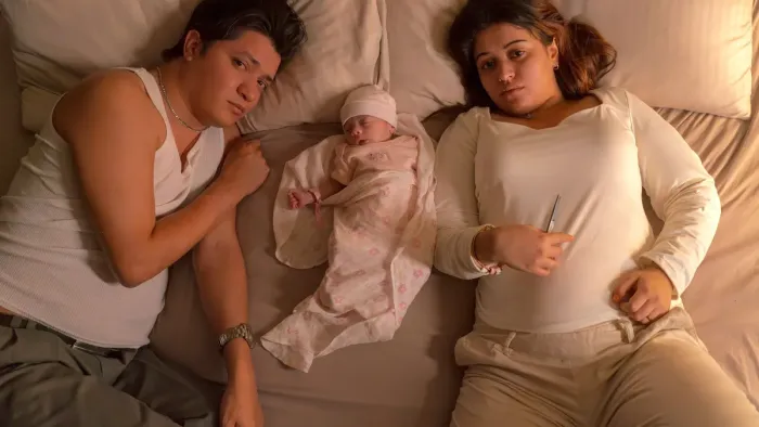A Child of My Own: Couple in bed with baby.