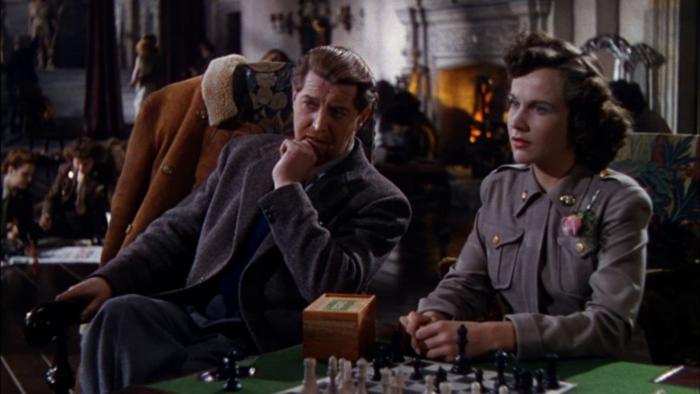 A Matter of Life and Death: Roger Livesey and Kim Hunter sit in a tea room, both looking at a character out of shot
