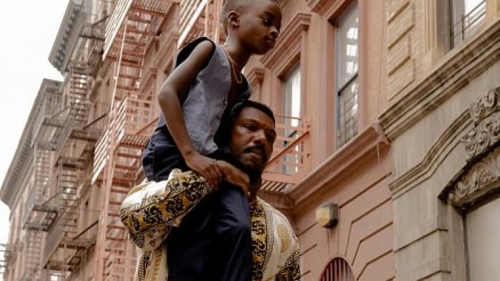A Thousand and One Movie: William Catlett holds Aaron Kingsley Adetola on his shoulder
