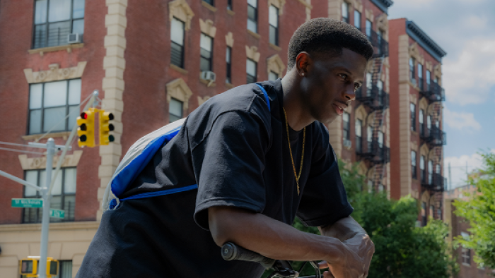 A Thousand and One Movie: Josiah Cross leans over while leaning on his bike