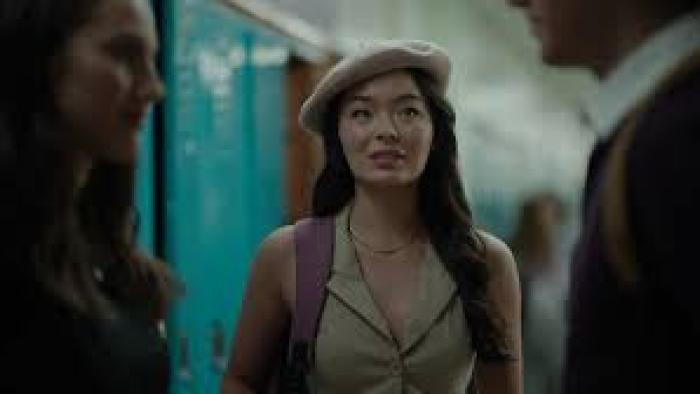 Abducted on Prom Night: Young woman in beret smiles in hallway