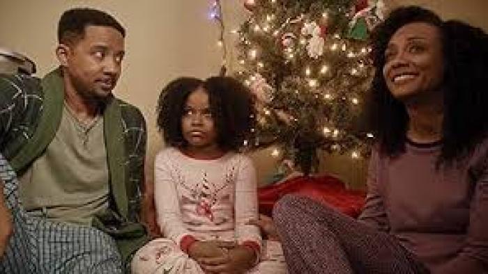 A Christmas Karen: Black family in pjs by Christmas tree