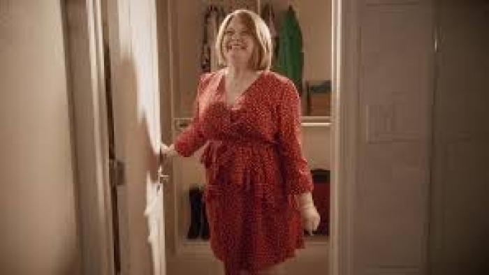 A Christmas Karen: Smiling White woman in doorway