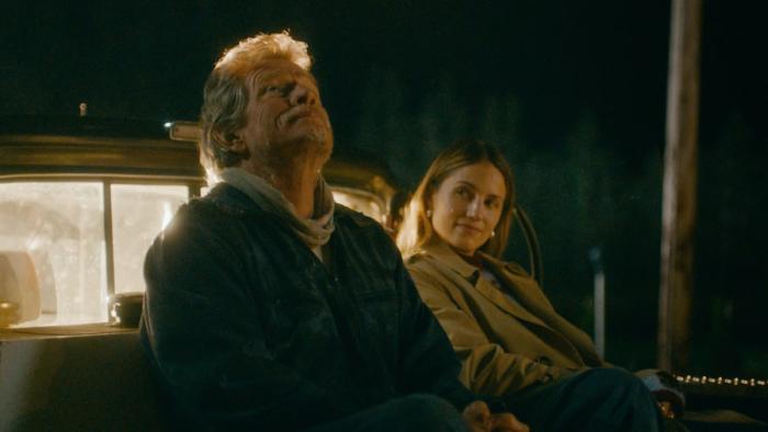 Acidman Movie: Thomas Haden Church and Dianna Agron hopefully watch the skies while sitting in the bed of a pickup truck.