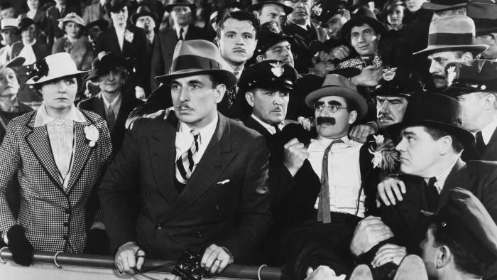 A Day at the Races Movie: Black and white crowd scene of adults at a horse race