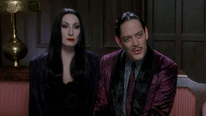 The Addams Family Movie: Morticia and Gomez sit on a red sofa