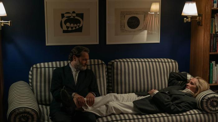 After the Hunt movie: Frederik (Michael Stuhlbarg) rubs the feet of his wife, Alma (Julia Roberts), while she lies on a striped couch