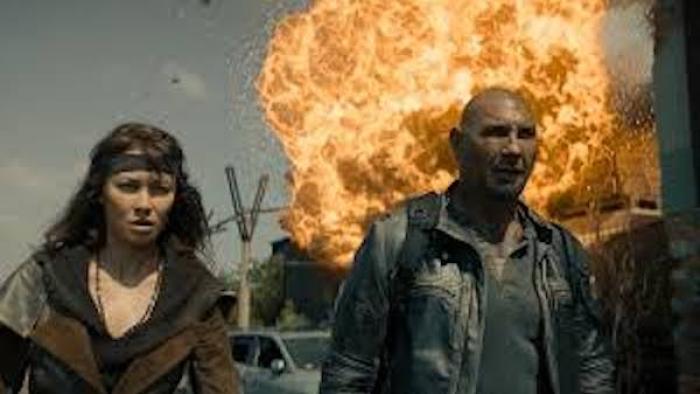 Afterburn: Dave Bautista and Olga Kurylenko walk away from an explosion.