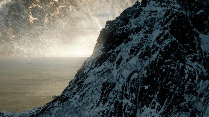 After Death Movie: Depiction of what Heaven might look like, with a giant wave of light and music rising up into the sky behind a mountain formation