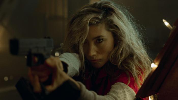 Aftermath movie: Asian Australian woman with blond hair center points handgun at target