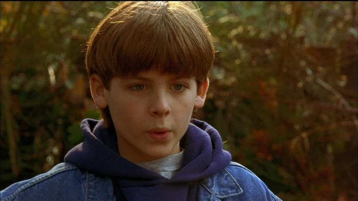 Air Bud Movie: Close-up on a White boy who has his lips pursed.