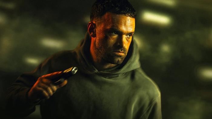 AKA: French White man in hoodie center holds gun in right hand