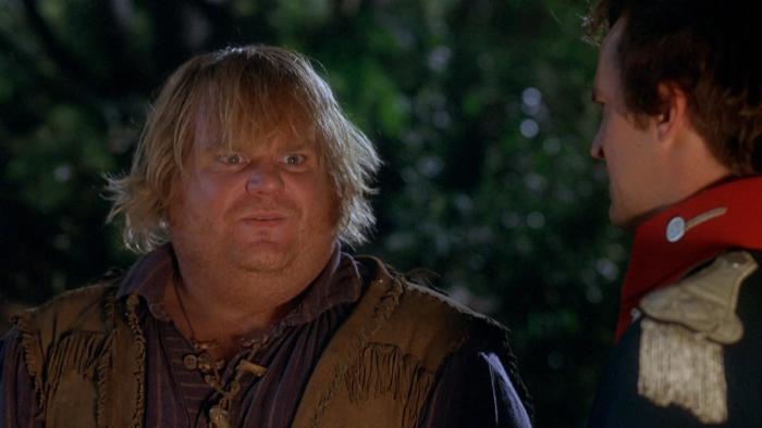 Almost Heroes movie: Chris Farley dressed like a fur trapper center left speaks to Matthew Perry right in coat with high red collar, shoulder tassel