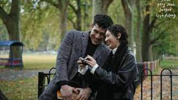 A Long Way to Come Home Scene 3: A woman and man cuddle on a park bench