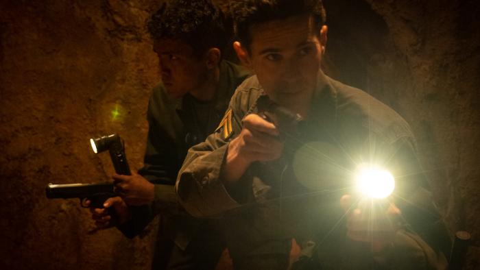 Ambush Movie: Mera (Jaime Lopez, left) and Ackerman (Connor Paolo, right) explore tunnels holding guns and flashlights