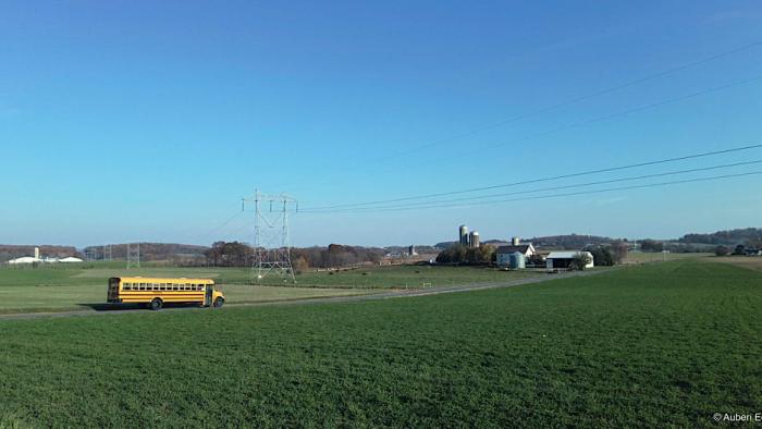 An American Pastoral movie: a school bus drives through an open field in Elizabethtown, Pennsylvania