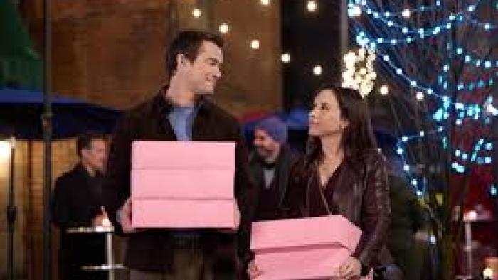 An Unexpected Valentine:  Robert Buckley and Lacey Chabert hold pink boxes