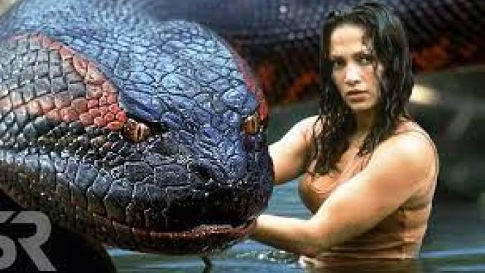 Anaconda Movie: Terri pets a giant snake head while looking confident