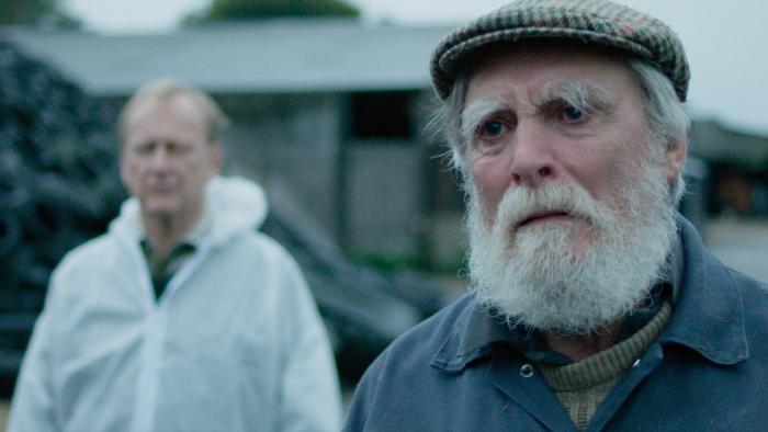 And Then Come the Nightjars: Nigel Hastings in a white hazmat suit, David Fielder with a white beard looks sad
