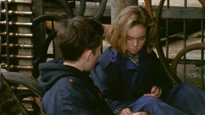 An Angel for May: Tom looks at May as the two sit in a barn together 