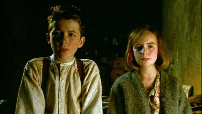 An Angel for May: Tom and May stand together inside a living room