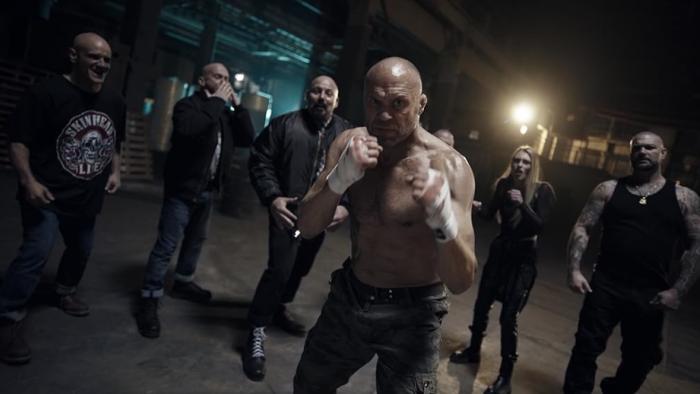 Angels Fallen -- Warriors of Peace: A shirtless Randy Couture bare knuckle boxing surrounded by skinheads