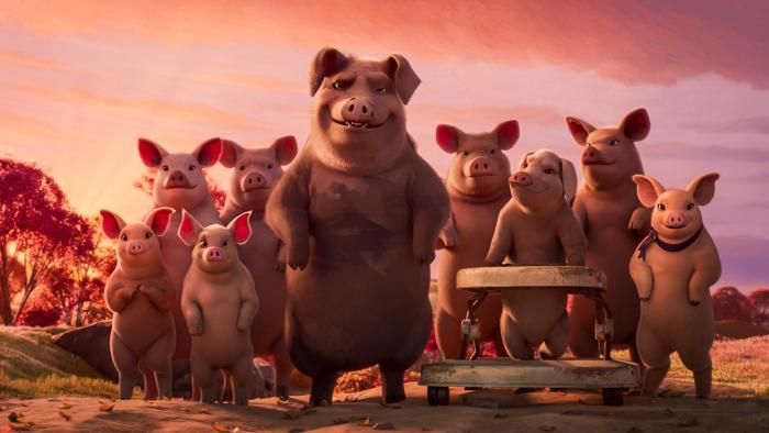 Animal Farm movie: A group of pigs stands on their hind legs, including one in a baby walker