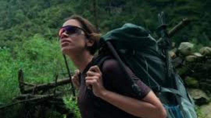 Larissa: The Other Side of Anitta: A woman backpacks in a forest