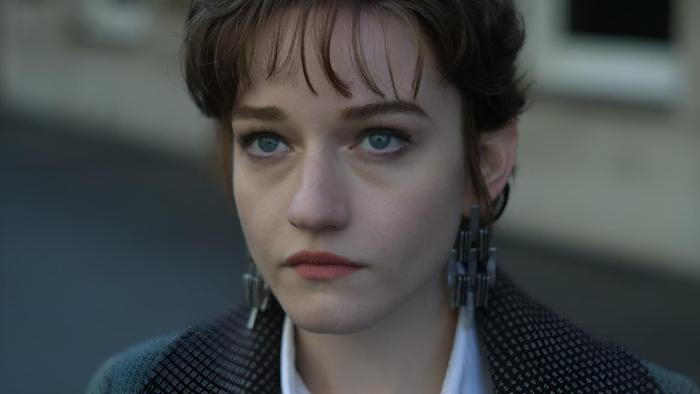 Apartment 7A movie: Julia Garner center looks upward while standing on the street