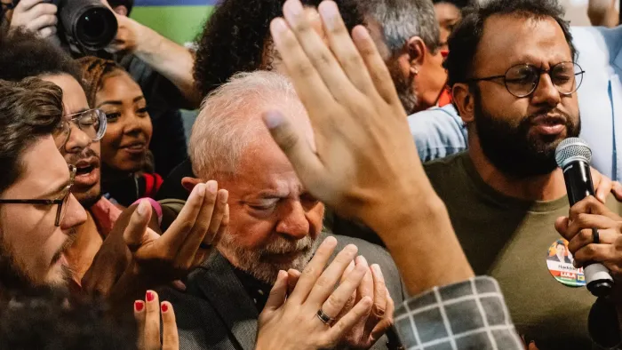 Apocalypse in the Tropics movie: Brazilians bow their heads and pray, some with their hands raised, others with cameras out