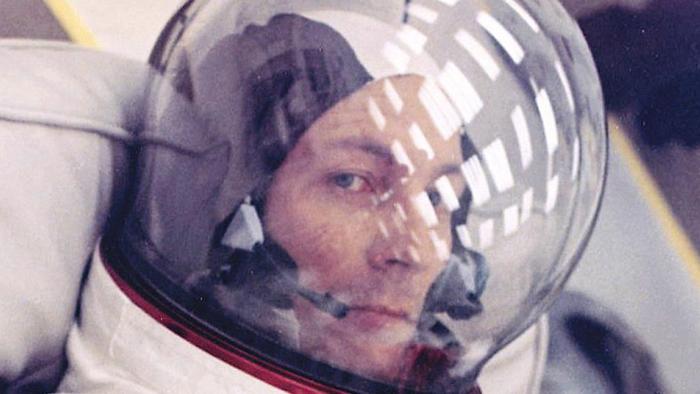 Apollo 13: Survival: Astronaut in helmet looks at camera.