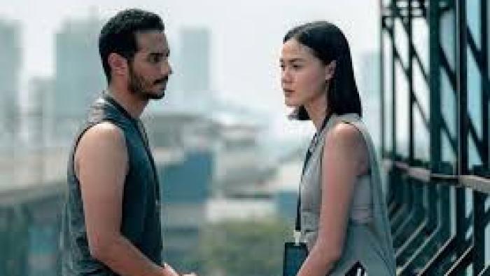 Arini by Love.inc: Indonesian man in sleeveless black shirt left stands on rooftop facing Indonesian woman right also in sleeveless shirt