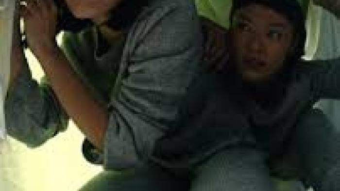 Arini by Love.inc: Facing forward, 2 Indonesian woman in grey pajamas crouch their way under a table