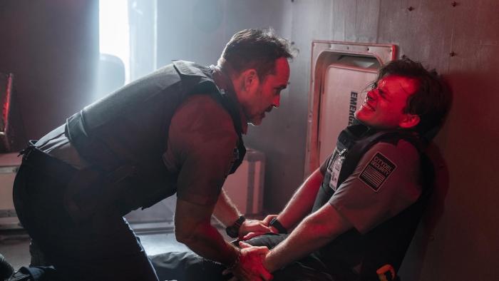 Armor Movie: Inside the truck and bathed in red light, James (Jason Patric) tries to calm an injured Casey (Josh Wiggins)
