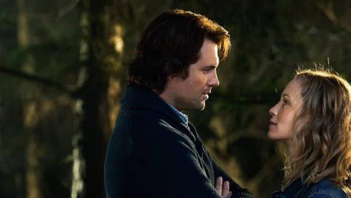 Atlas Shrugged III: Man and woman gazing at each other in a forest setting.