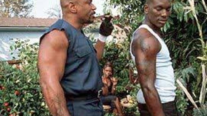 Baby Boy: Two Black men in tank tops walk outside