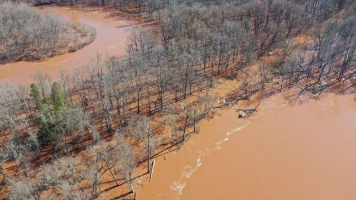 Bad River movie: Line 5 of an oil pipeline cutting through the orange and brown waters of the Bad River
