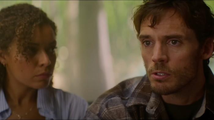 Bagman Movie: Karina (Antonia Thomas) and Pat (Sam Claflin) appear to be having a serious conversation with someone